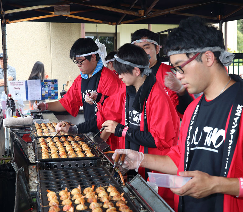 Visitors enjoying authentic Japanese festival food